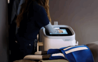 Man relaxing during a CoolTone treatment session focused on abdominal toning.