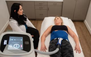 A client experiencing a CoolTone session at Bodify Med Spa. Learn what CoolTone feels like and how this non-surgical body contouring treatment helps you build strength and tone your abs, glutes, and thighs—schedule your free consultation today with Bodify Med Spa.